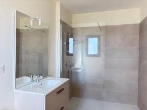 a white bathroom with a sink and a shower at Claïla Appart-Hôtel Abzac in Abzac +57 photos