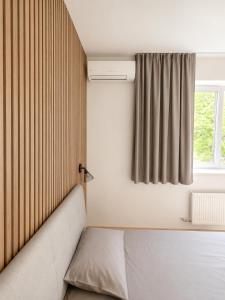 a bedroom with a bed and a window at Glūdas Grava in Cēsis