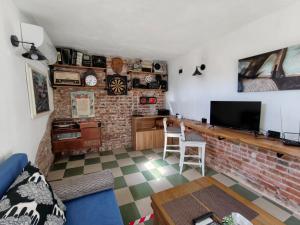 a living room with a brick wall at Skalolazka 2 in Belogradchik