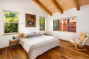 a bedroom with a large bed and two windows at Nama-Stay Retreat Village in Springdale