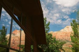 a room with a view of the mountains through a window at Nama-Stay Retreat Village in Springdale