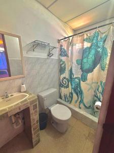 a bathroom with a toilet and a shower curtain at Beachside Cabana with Pool & Beach Access in Nueva Gorgona +20 photos