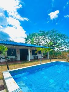 a swimming pool in front of a house at Beachside Cabana with Pool & Beach Access in Nueva Gorgona
