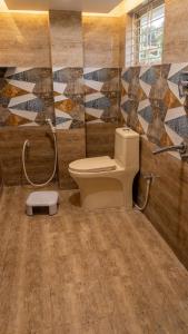 a bathroom with a toilet and a shower at SVL HomeStay in Chik Ballāpur
