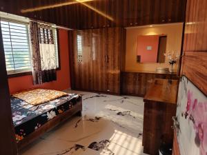 a room with a bed and a smashed floor at SVL HomeStay in Chik Ballāpur +8 photos