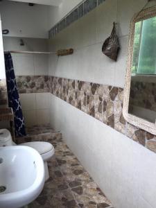 a bathroom with a toilet and a sink at Renacer de Gaia 888 in Mompiche