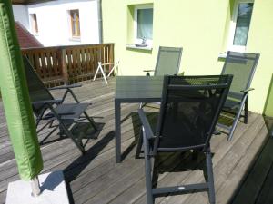 a table and chairs sitting on a deck at Ferienhaus Lisa in Selb