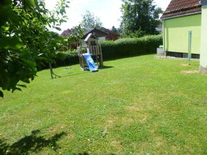 a yard with a playground and a gazebo at Ferienhaus Lisa in Selb