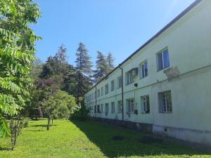 a building with a grass yard next to a building at Elasia in Martvili