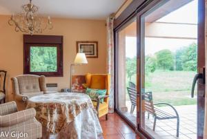 a dining room with a table and a sliding glass door at La Xana de Peón AVG in Candanal