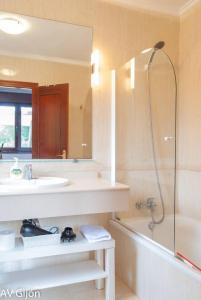 a bathroom with a sink and a shower and a tub at La Xana de Peón AVG in Candanal +42 photos