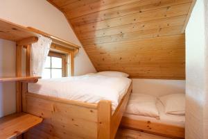 a bedroom in a log cabin with a bed at my Hütten Katschberg in Katschberghöhe