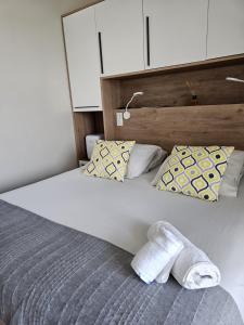 a bed with a towel laying on top of it at Le Cannier Hotel in La Seyne-sur-Mer