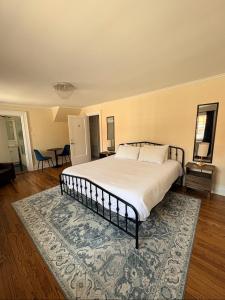 a bedroom with a large bed with a rug at The Ambassador in Ottawa