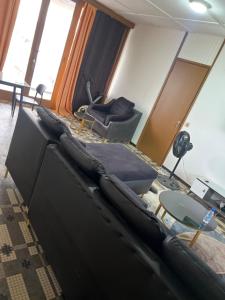 a living room with a couch and a table at Colonial Appart Boss in Bouaké