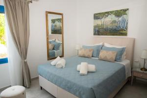 a bedroom with a blue bed with white pillows at Casa Maritina Gennadi Traditional House in Gennadi
