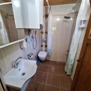 a bathroom with a sink and a toilet at Katipogulları Apart in Uzungöl +18 photos