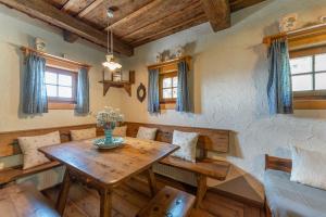 a dining room with a wooden table and chairs at my Hütten Katschberg in Katschberghöhe