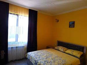 a bedroom with a bed and a large window at CityHaven in Ureki