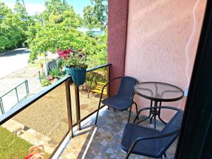 a patio with two chairs and a table on a balcony at CityHaven in Ureki