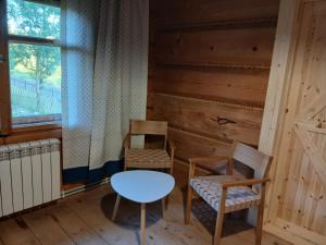 a room with two chairs and a table and a window at Bauernhaus in Dzianisz