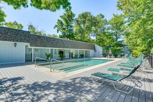 a group of lounge chairs next to a swimming pool at Private Dock & Resort Access: Margaritaville Cabin in Osage Beach