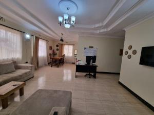 a living room with a couch and a table at Friendly hostel in Arusha