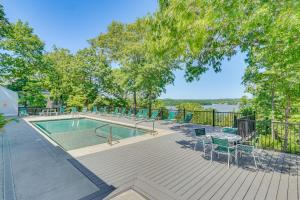 a swimming pool on a deck with chairs and a table at Private Dock & Resort Access: Margaritaville Cabin in Osage Beach