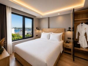 a bedroom with a large bed and a large window at Art Karakoy Hotel in Istanbul