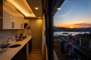 a kitchen with a window with a view of a city at Art Karakoy Hotel in Istanbul