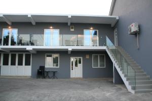 a building with a staircase on the side of it at B-I Apartmani in Glavatske Kućice