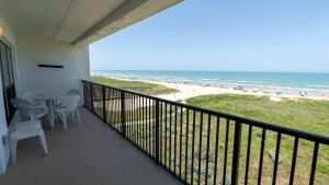 a balcony with a table and chairs and the beach at Beachfront 2BR 5th Floor Views Wakable SPI in South Padre Island