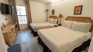 a hotel room with two beds and a television at Beachfront 2BR 5th Floor Views Wakable SPI in South Padre Island