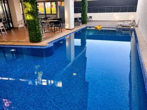 a large pool with blue water in a building at Oceana Mazagan Suites Hôtel in El Jadida
