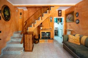 a living room with a staircase and a fireplace at Villetta Dina in Scoffera