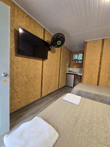 a bedroom with a bed with a flat screen tv at EcoHotel Farallones in San Pedro de Jagua