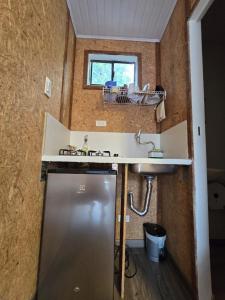 a small kitchen with a sink and a refrigerator at EcoHotel Farallones in San Pedro de Jagua