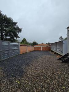 a large parking lot with a fence and trailers at EcoHotel Farallones in San Pedro de Jagua +17 photos