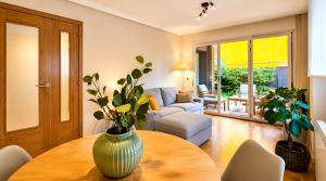 a living room with a vase on a wooden table at Apto Llanes Bajo con terraza - Casa Juanín in Llanes