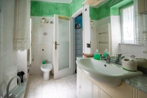 a bathroom with a sink and a toilet at Villetta Dina in Scoffera +19 photos