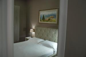 a bedroom with a bed and a picture on the wall at KAIROS - Centro di Oliveto Citra in Oliveto Citra