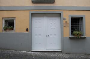 a white door on the side of a building at KAIROS - Centro di Oliveto Citra in Oliveto Citra +3 photos