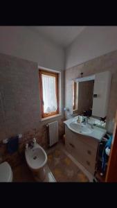 a bathroom with a sink and a toilet and a mirror at Da Ross in Castel di Sangro +13 photos