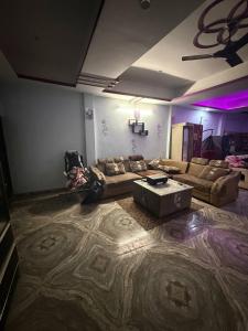 a living room with a couch and a table at Dixit's Villa! in Kānpur +2 photos