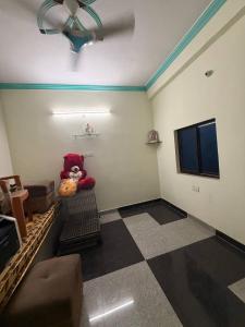 a room with a teddy bear sitting on a shelf at Dixit's Villa! in Kānpur
