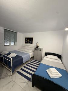 a bedroom with two beds with towels on them at Sun & Sea in Sounio