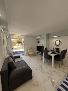 a living room with a couch and a table at Sun & Sea in Sounio
