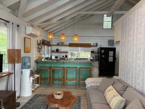 a living room with a couch and a table at Beachfront Bungalow-Pool & Oceanfront-Views-Golf in Seine Bight Village