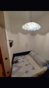 a small bedroom with a bed and a light at Da Ross in Castel di Sangro