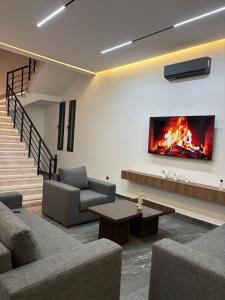 a living room with a fire on the wall at villa HLH in Tangier